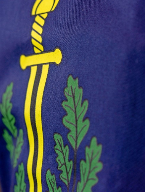 Tabard with silk-screening of scarlet dots, golden swords, and green oak leaves 
